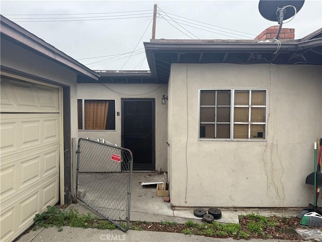 3754 Grace Ave, Baldwin Park, CA 91706 - property entrance with stucco siding, an attached garage, and a gate