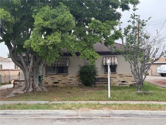 3754 Grace Ave, Baldwin Park, CA 91706 - view of front of property with stone siding, stucco siding, roof with shingles, and fence