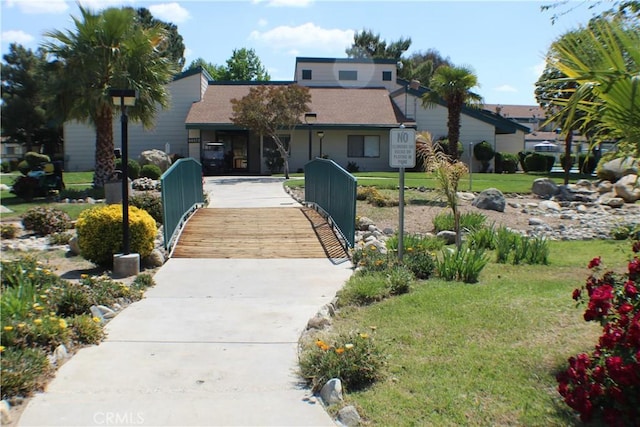 44406 15th St E Unit 13, Lancaster, CA 93535 - view of front of home with a front lawn and roof with shingles