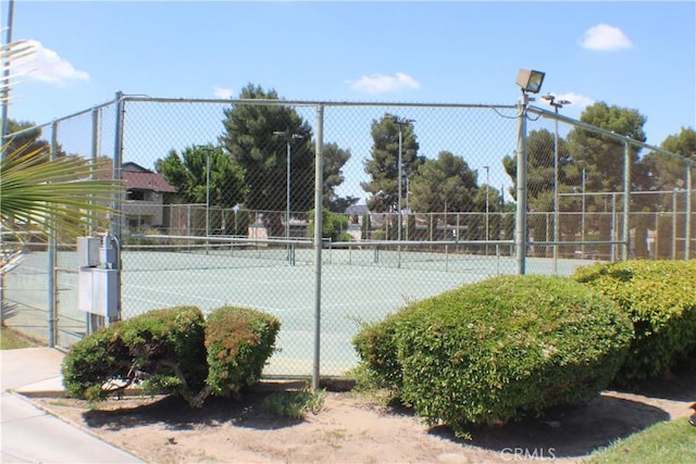 view of sport court featuring fence