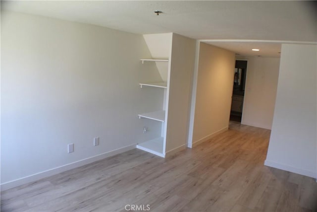 empty room featuring baseboards and wood finished floors