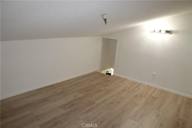 44406 15th St E Unit 13, Lancaster, CA 93535 - additional living space featuring light wood finished floors, a textured ceiling, and lofted ceiling