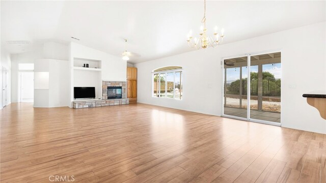 13912 Riverside Dr, Apple Valley, CA 92307 - unfurnished living room featuring built in shelves, a notable chandelier, light wood-style flooring, and vaulted ceiling