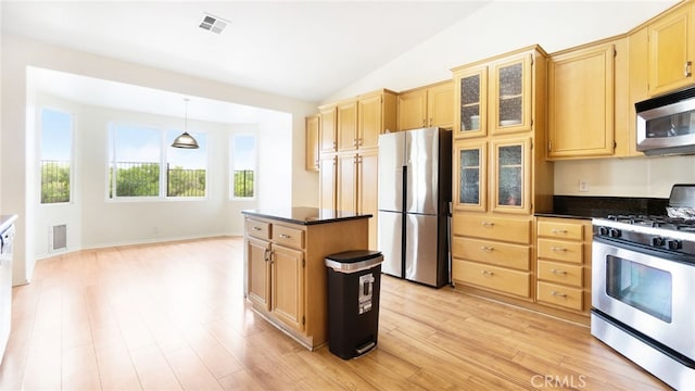 13912 Riverside Dr, Apple Valley, CA 92307 - kitchen featuring stainless steel appliances, visible vents, vaulted ceiling, light brown cabinets, and dark countertops