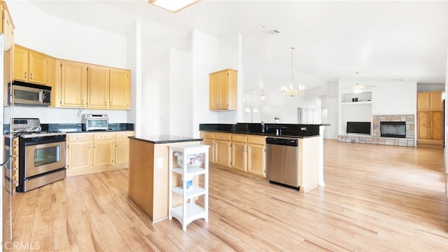 13912 Riverside Dr, Apple Valley, CA 92307 - kitchen featuring stainless steel appliances, open shelves, light wood-type flooring, a chandelier, and dark countertops