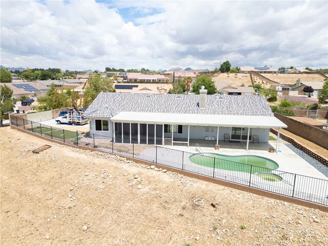 13912 Riverside Dr, Apple Valley, CA 92307 - rear view of property featuring a patio, a residential view, a chimney, a fenced backyard, and a fenced in pool