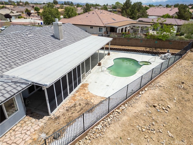 13912 Riverside Dr, Apple Valley, CA 92307 - exterior space with a sunroom, a chimney, a residential view, and a fenced backyard