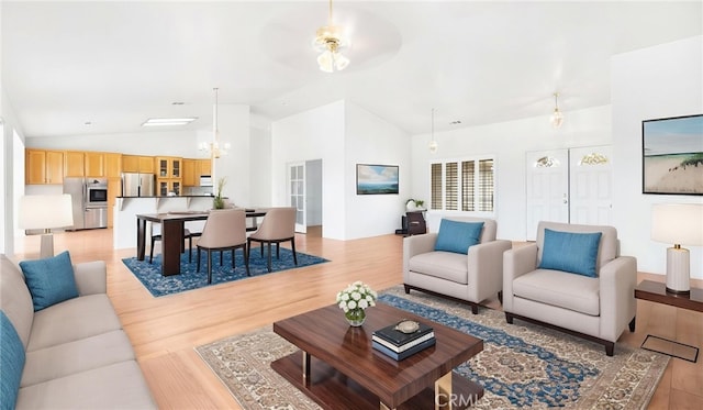 13912 Riverside Dr, Apple Valley, CA 92307 - living area featuring lofted ceiling, ceiling fan with notable chandelier, and light wood-type flooring