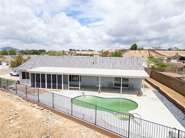 13912 Riverside Dr, Apple Valley, CA 92307 - view of pool featuring a sunroom, a patio, a fenced in pool, and a fenced backyard