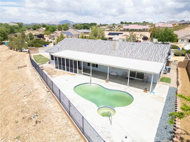 13912 Riverside Dr, Apple Valley, CA 92307 - view of swimming pool featuring a fenced in pool, a patio area, a residential view, a sunroom, and a fenced backyard