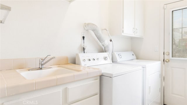 13912 Riverside Dr, Apple Valley, CA 92307 - washroom with washing machine and clothes dryer, a sink, and cabinet space