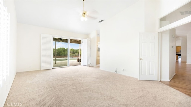 13912 Riverside Dr, Apple Valley, CA 92307 - carpeted empty room with a ceiling fan, visible vents, and a towering ceiling