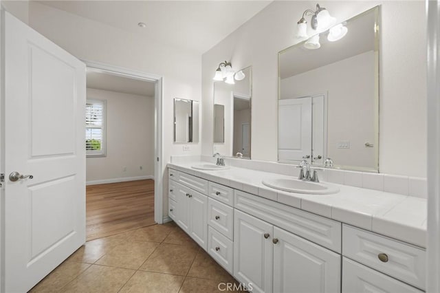 13031 Villosa Pl Unit 437, Playa Vista, CA 90094 - bathroom with double vanity, tile patterned flooring, baseboards, and a sink