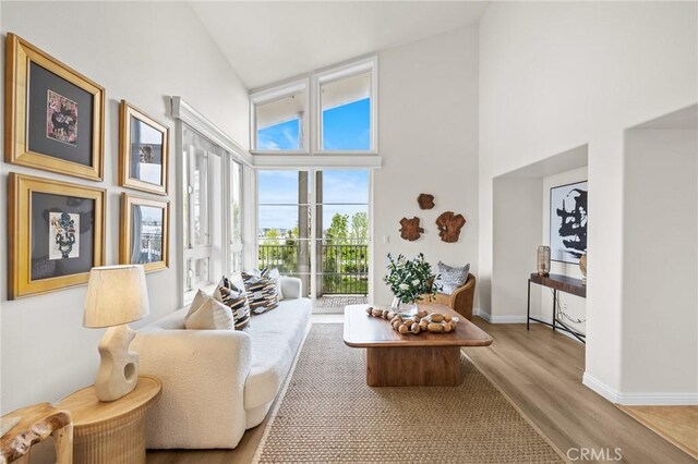 13031 Villosa Pl Unit 437, Playa Vista, CA 90094 - living area with baseboards, high vaulted ceiling, and wood finished floors