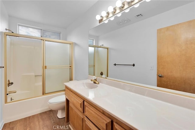 61652 Pueblo Trl, Joshua Tree, CA 92252 - full bath featuring toilet, wood finished floors, vanity, visible vents, and shower / bath combination with glass door
