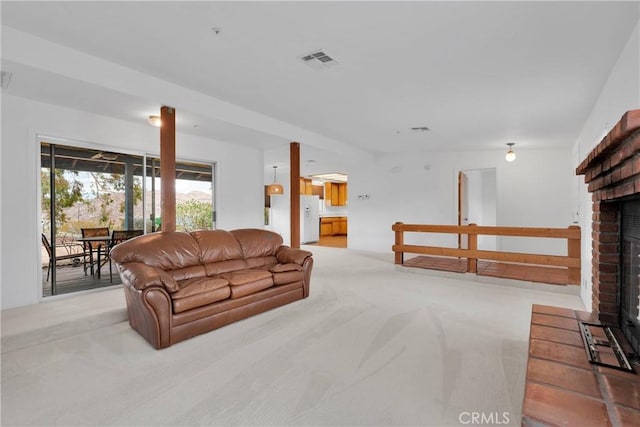 61652 Pueblo Trl, Joshua Tree, CA 92252 - living area featuring light carpet, a fireplace, and visible vents