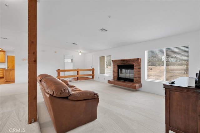61652 Pueblo Trl, Joshua Tree, CA 92252 - living room with light colored carpet, visible vents, a fireplace, and lofted ceiling