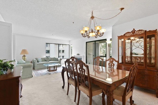 carpeted dining area featuring a textured ceiling and a notable chandelier
