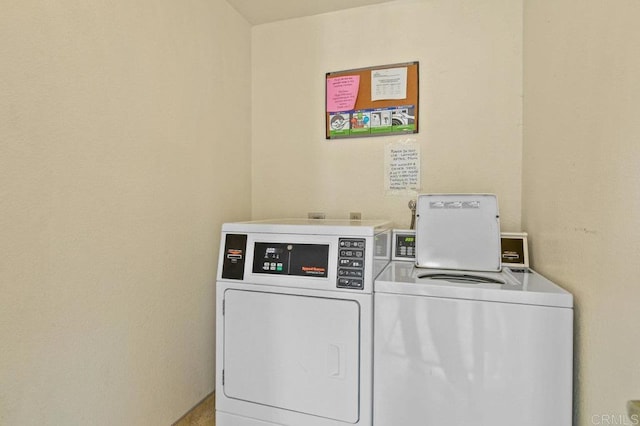 community laundry room featuring washing machine and dryer