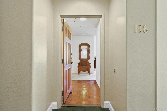 hall with attic access and baseboards