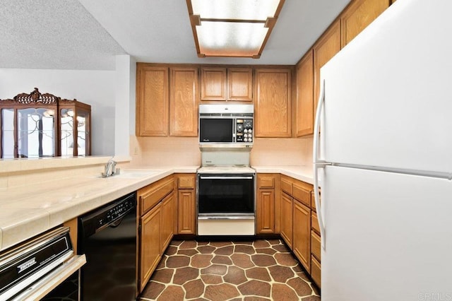 kitchen featuring a sink, tasteful backsplash, white appliances, and brown cabinets