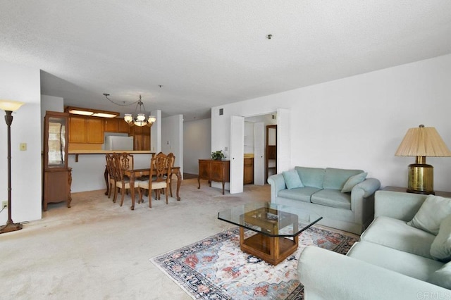 living area featuring a chandelier, a textured ceiling, and light colored carpet