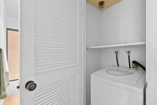 laundry room featuring washer / clothes dryer and laundry area