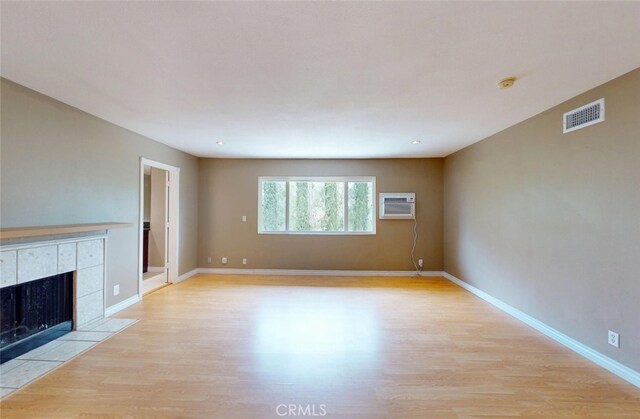 25211 Barents, Laguna Hills, CA 92653 - unfurnished living room featuring light wood-type flooring, visible vents, and an AC wall unit