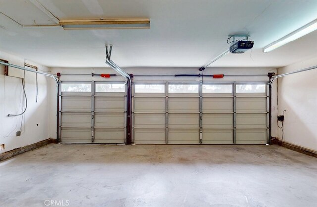 25211 Barents, Laguna Hills, CA 92653 - garage with baseboards and a garage door opener