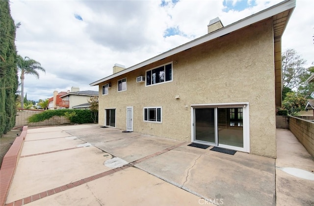 25211 Barents, Laguna Hills, CA 92653 - back of house with stucco siding and a chimney