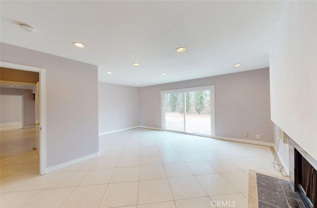 25211 Barents, Laguna Hills, CA 92653 - unfurnished living room featuring baseboards, a fireplace with flush hearth, recessed lighting, and light tile patterned flooring