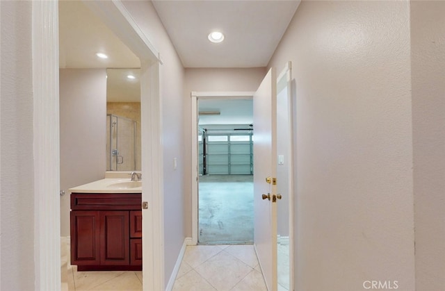 25211 Barents, Laguna Hills, CA 92653 - hall featuring light tile patterned floors, baseboards, recessed lighting, and a sink