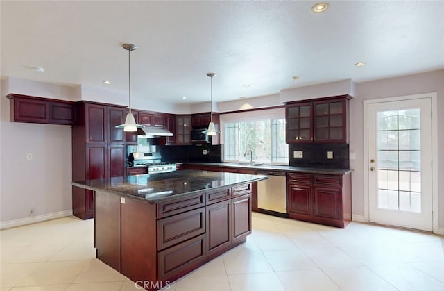 25211 Barents, Laguna Hills, CA 92653 - kitchen featuring backsplash, baseboards, dark brown cabinets, and appliances with stainless steel finishes