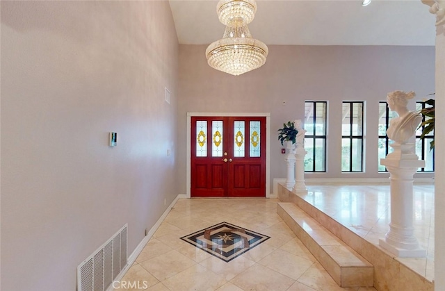 25211 Barents, Laguna Hills, CA 92653 - foyer entrance with light tile patterned floors, visible vents, baseboards, a towering ceiling, and a chandelier