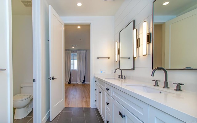 full bath featuring a sink, tile patterned flooring, double vanity, and recessed lighting