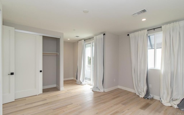 unfurnished bedroom featuring baseboards, recessed lighting, light wood finished floors, and visible vents