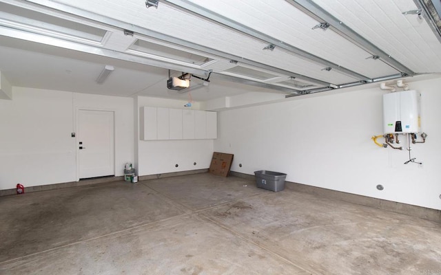 garage featuring water heater and a garage door opener