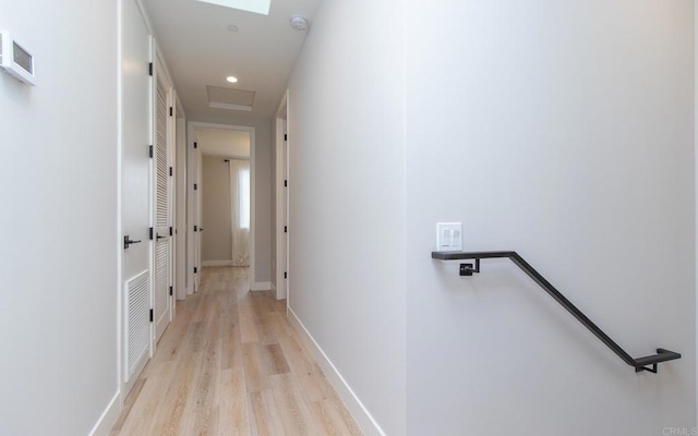 corridor featuring an upstairs landing, recessed lighting, visible vents, light wood-style flooring, and baseboards