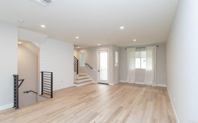 interior space featuring recessed lighting, baseboards, visible vents, stairs, and wood finished floors