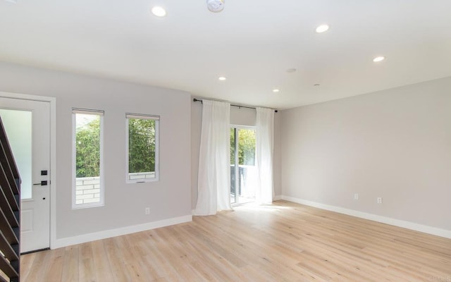 interior space featuring recessed lighting, baseboards, and light wood-style floors