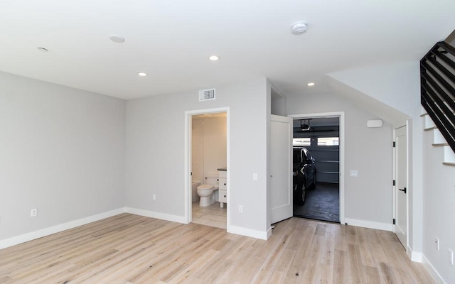unfurnished bedroom featuring light wood-style floors, visible vents, a spacious closet, and recessed lighting