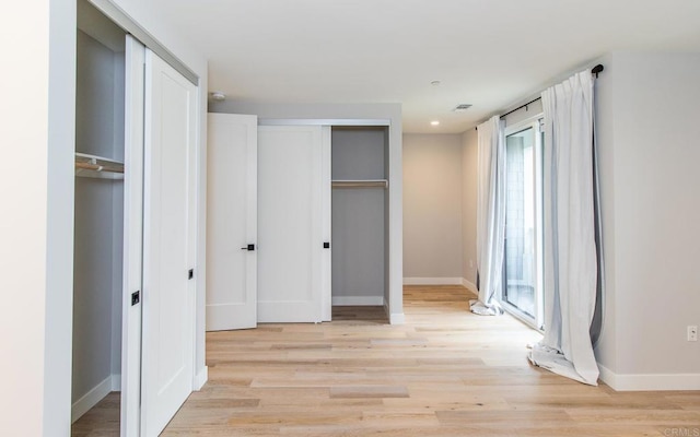 3341 Tyler St, Carlsbad, CA 92008 - unfurnished bedroom with light wood-style floors, baseboards, and two closets