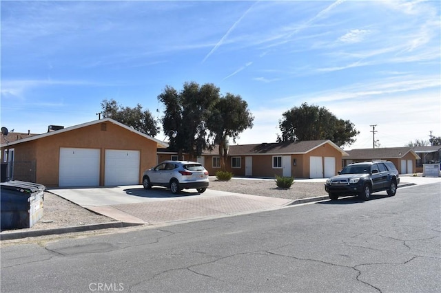 ranch-style home with stucco siding and driveway