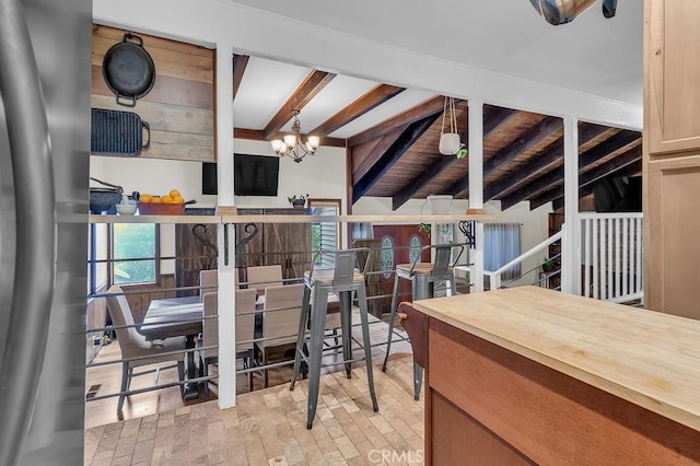 583 Arbula Dr, Crestline, CA 92325 - dining room with a chandelier, beam ceiling, and plenty of natural light