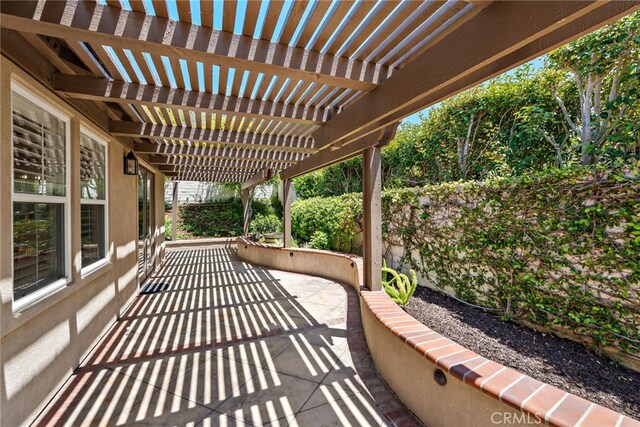 view of patio featuring a pergola and fence