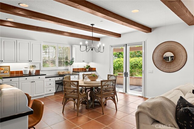 dining area with beam ceiling, healthy amount of natural light, tile patterned floors, recessed lighting, and a chandelier