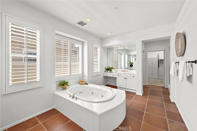bathroom with tile patterned floors, a whirlpool tub, vanity, baseboards, and recessed lighting