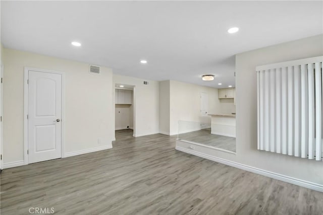 1023 S Citron St Unit 21, Anaheim, CA 92805 - unfurnished living room with light wood-style flooring, baseboards, and recessed lighting