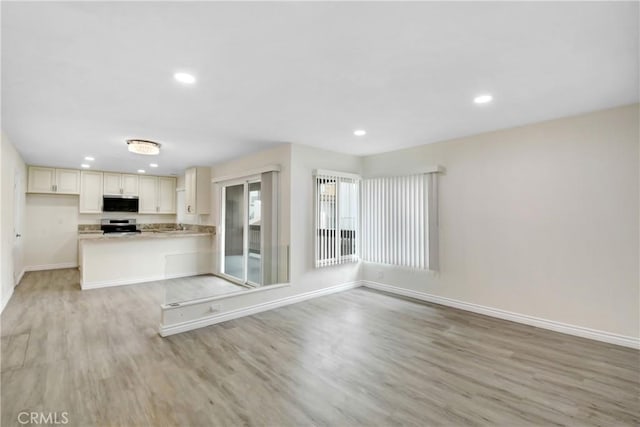 1023 S Citron St Unit 21, Anaheim, CA 92805 - kitchen with baseboards, light wood-style flooring, range, recessed lighting, and light countertops