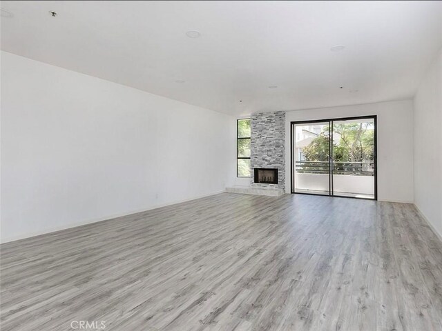 unfurnished living room featuring light wood-style flooring and a fireplace